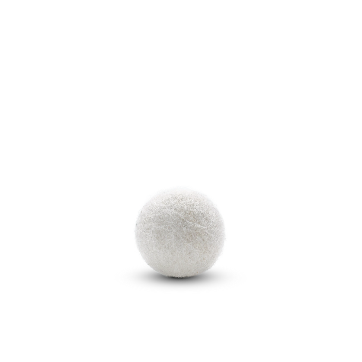 Single white felted wool ball cat toy on a light background.