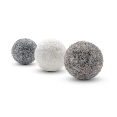 Three textured wool felt cat toy balls in off-white, light brown, and light gray, arranged diagonally on a white background.