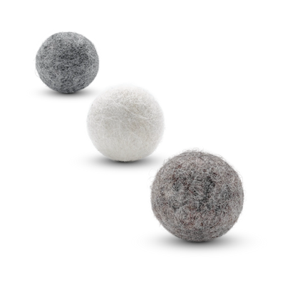 Three textured wool felt cat toy balls in off-white, light brown, and light gray, arranged diagonally on a white background.