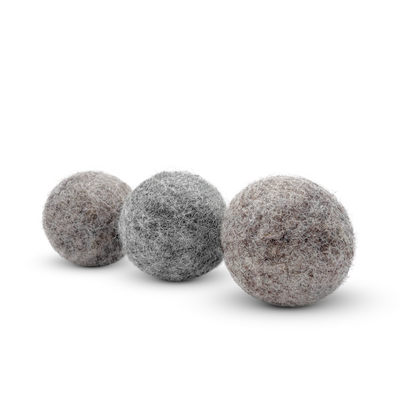 Three textured wool cat toy balls in gray, silver, and brown tones arranged diagonally on a clean white background.
