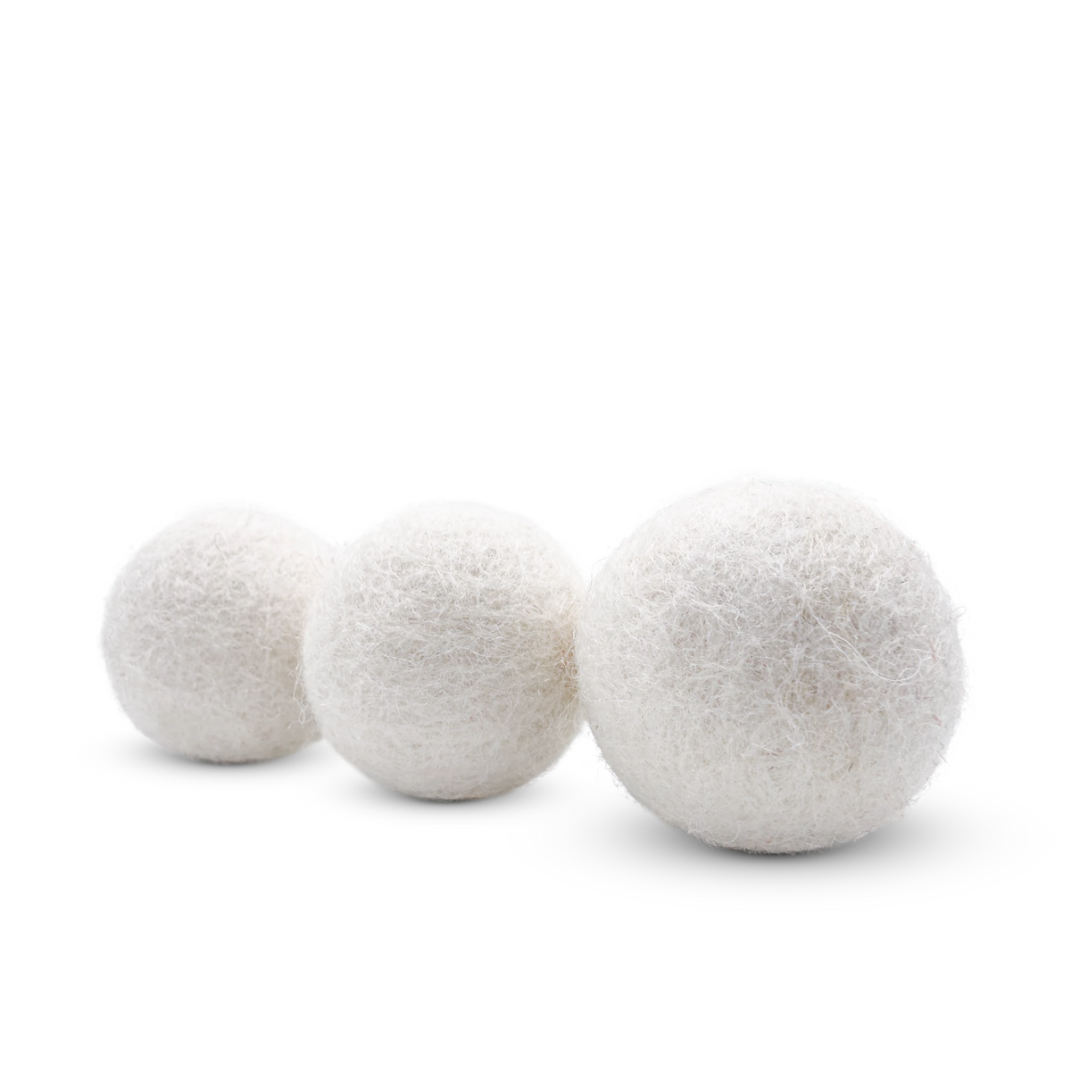 Three white felt cat toy balls arranged in a diagonal line on a clean white background.