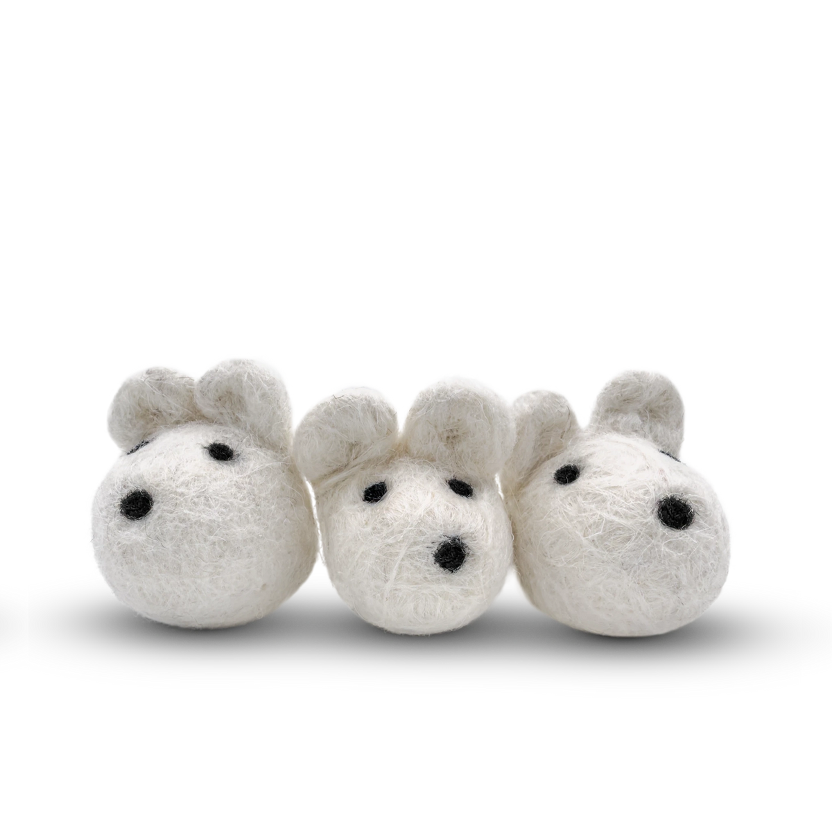 White felted wool mice cat toy on a light background.