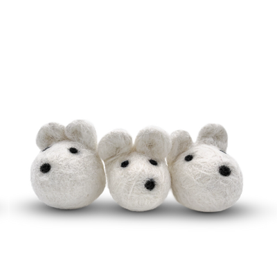 White felted wool mice cat toy on a light background.