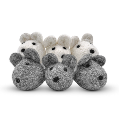 Group of grey and white felted wool mouse cat toys on a light background.