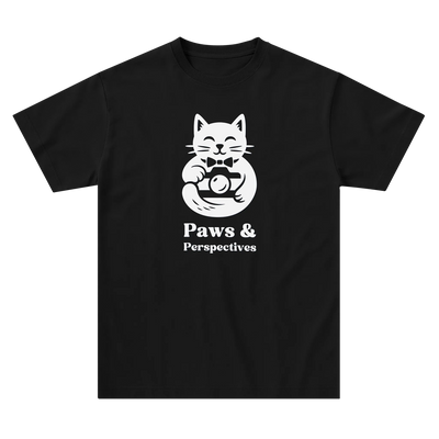 Black Paws & Perspectives cat graphic t-shirt laid flat on a light background.
